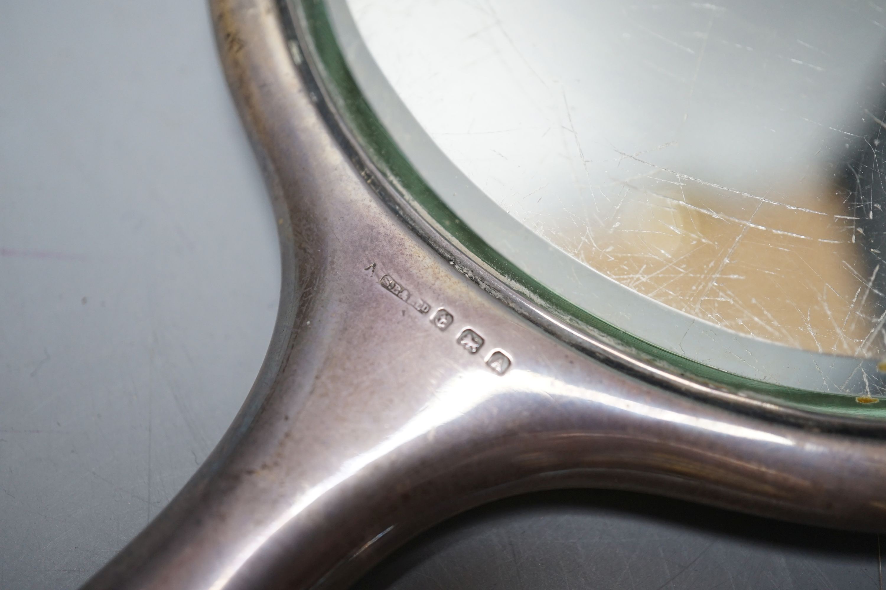 A silver two handled bowl, a silver mounted hand mirror, two silver and mother of pearl fruit knives, a silver preserve spoon and enamelled compact decorated with a dog.